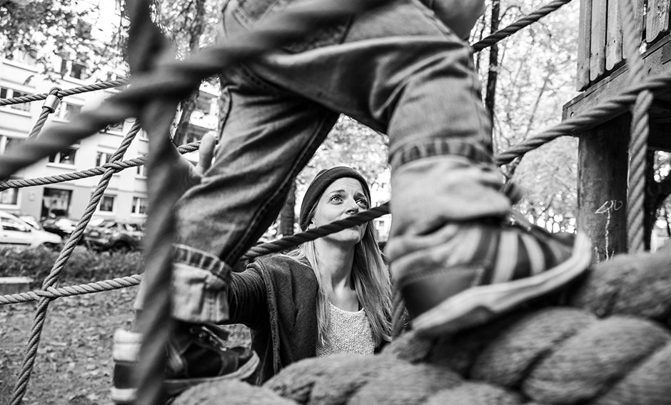 Familienfoto Sohn auf dem Klettergerüst